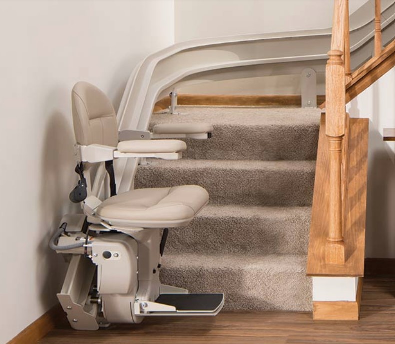 Example of a Bruno curved stair lift beside a home's wooden staircase